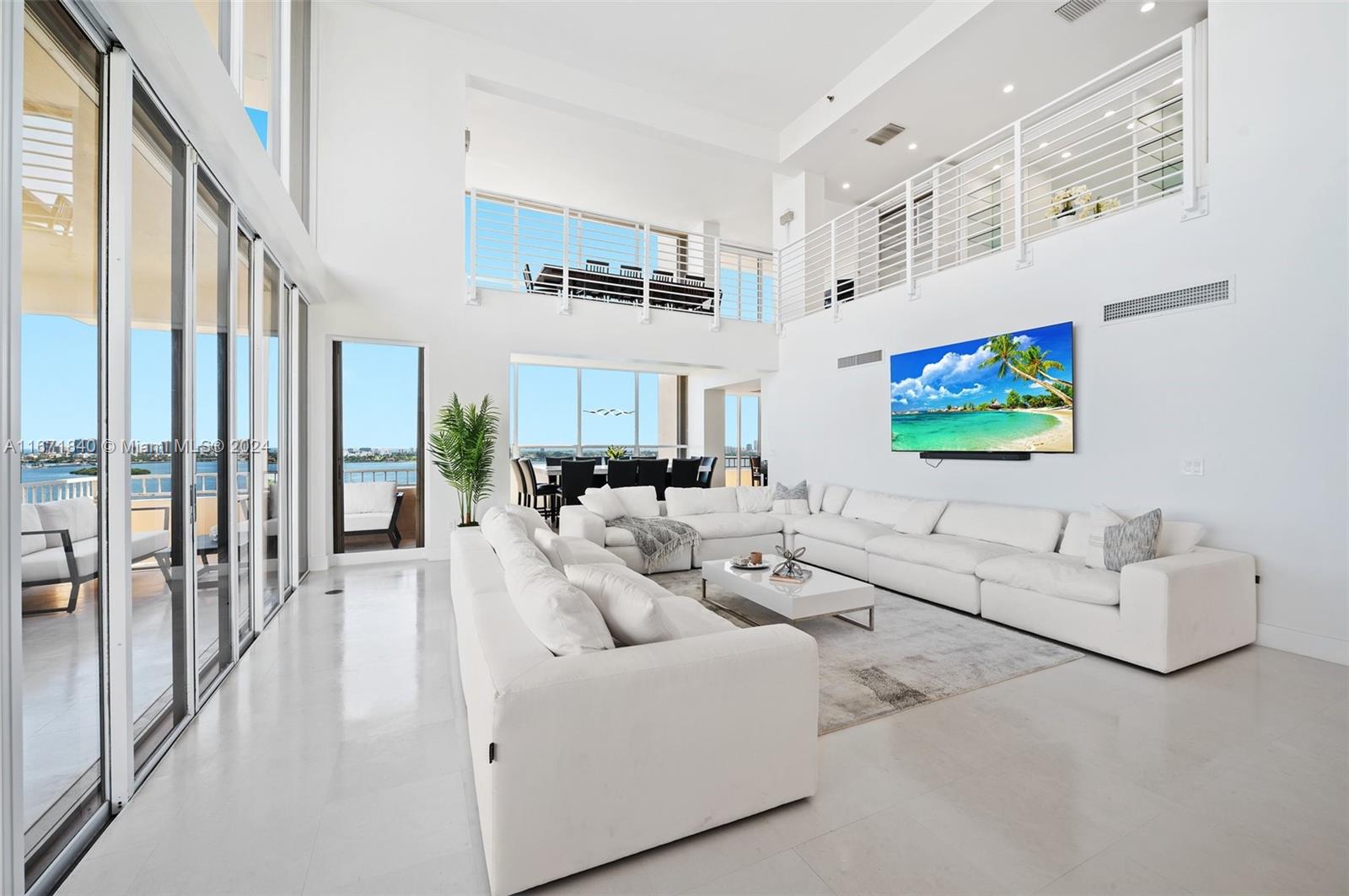 a living room with furniture wooden floor and a flat screen tv