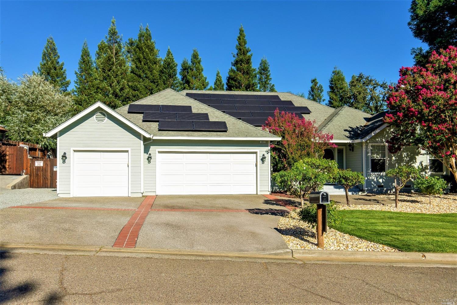 a view of a house with a yard and plants