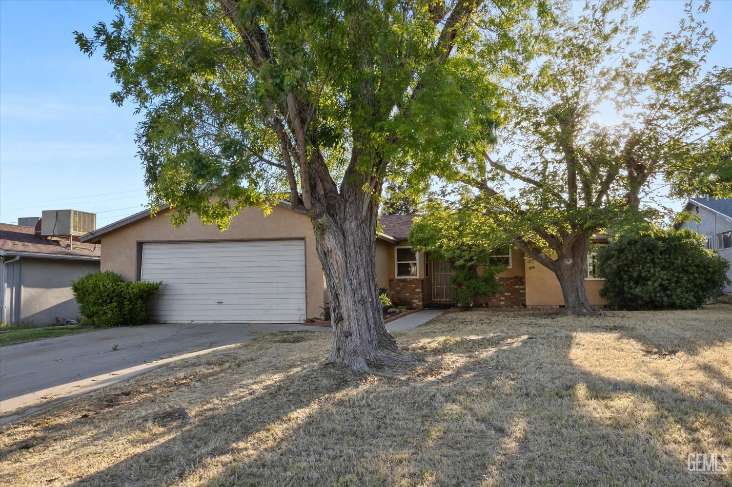 a view of a house with a tree in the background