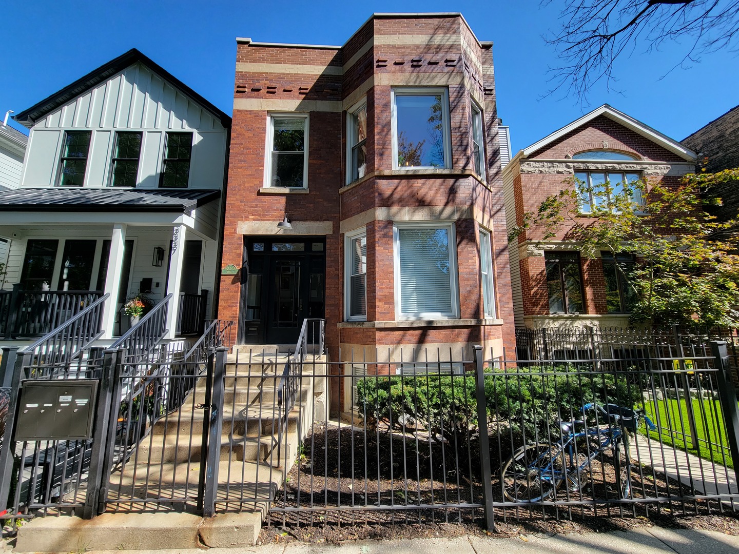 a front view of a residential apartment building with a yard