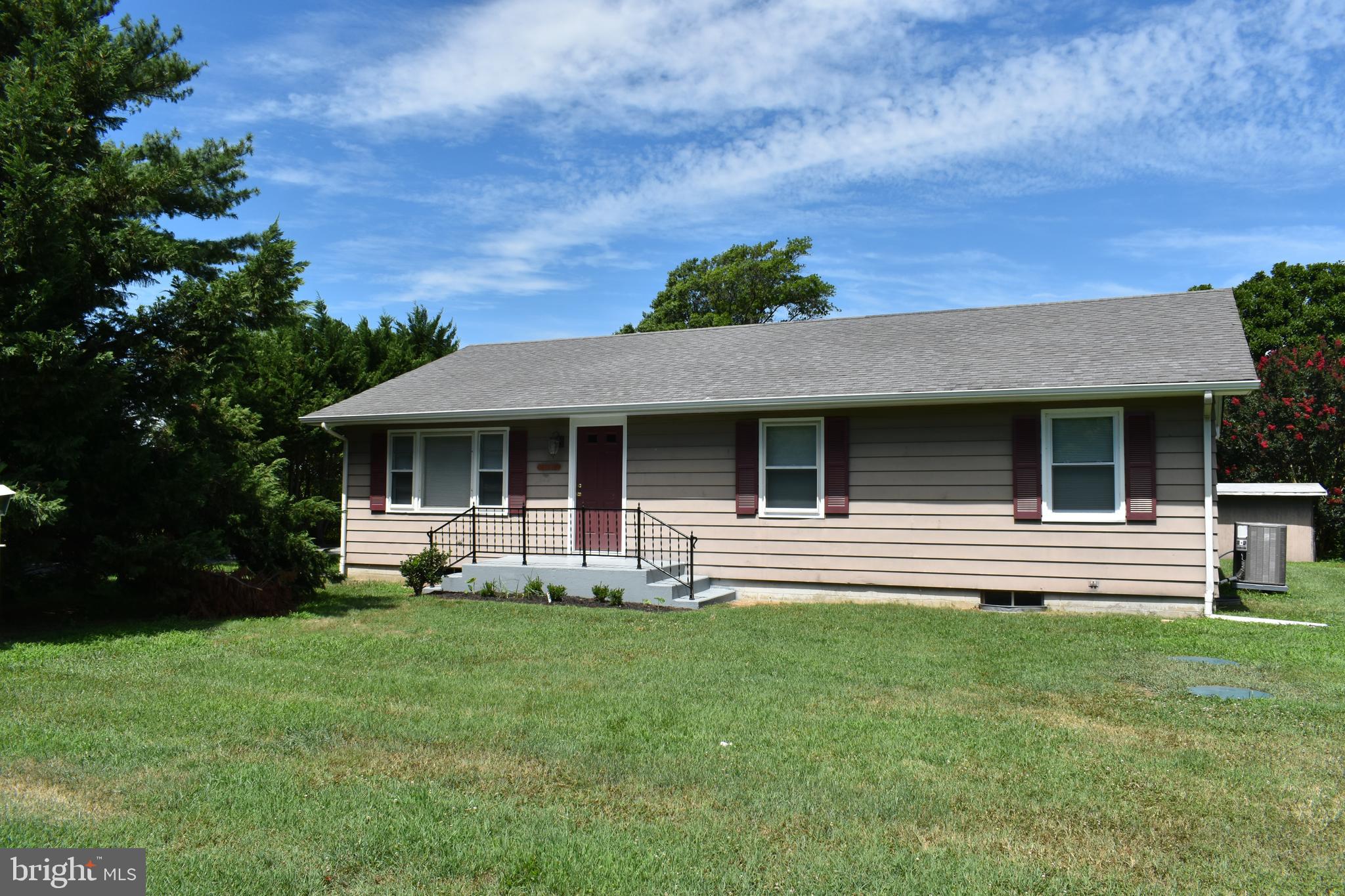 a front view of house with a garden and patio