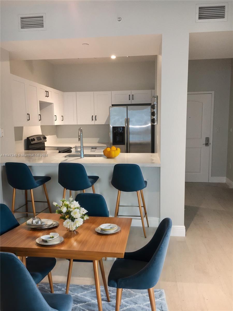 a kitchen with a dining table and chairs