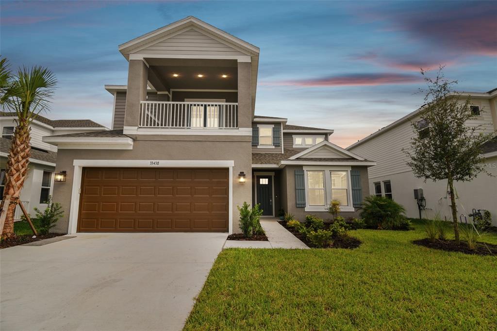 a front view of a house with a yard and garage