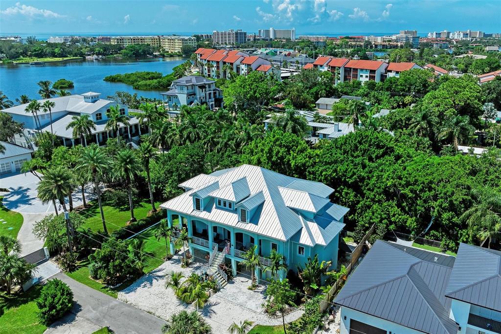 an aerial view of a house with outdoor space and lake view