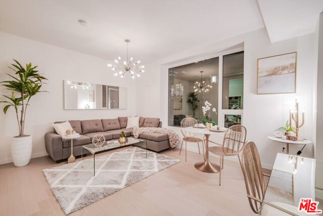 a living room with furniture and a chandelier