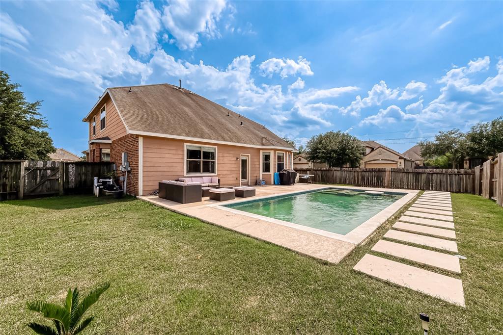 a view of a house with backyard porch and sitting area