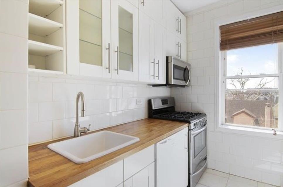 a kitchen with stainless steel appliances granite countertop a sink and a stove