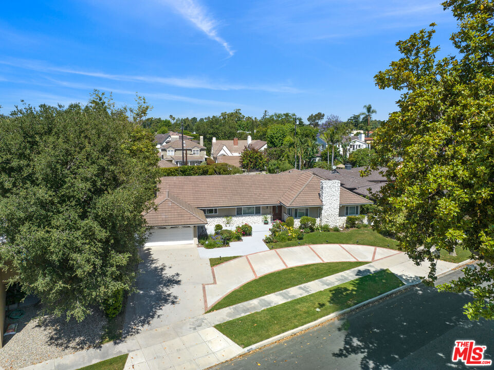 an aerial view of residential houses with outdoor space and street view