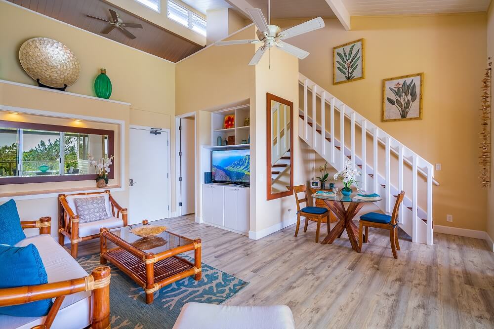 a living room with furniture and a wooden floor