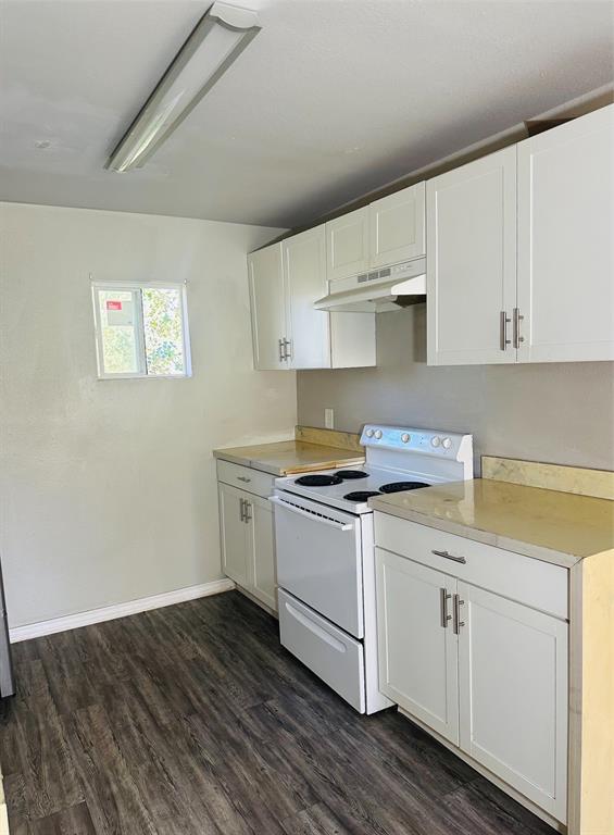 a kitchen with cabinets appliances a sink and a stove