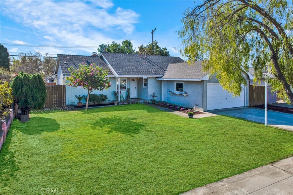 a front view of house with yard and green space