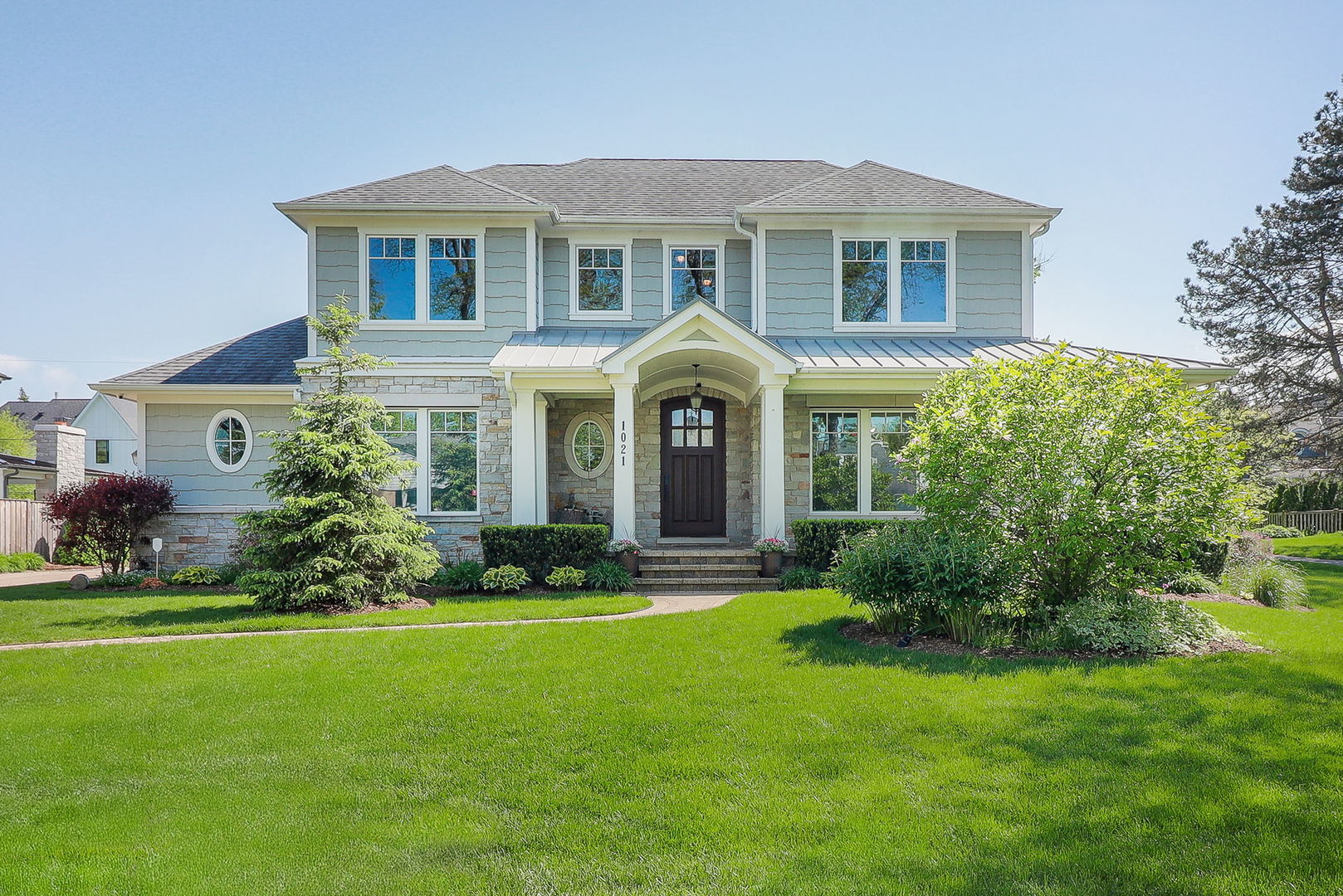 a front view of a house with a garden