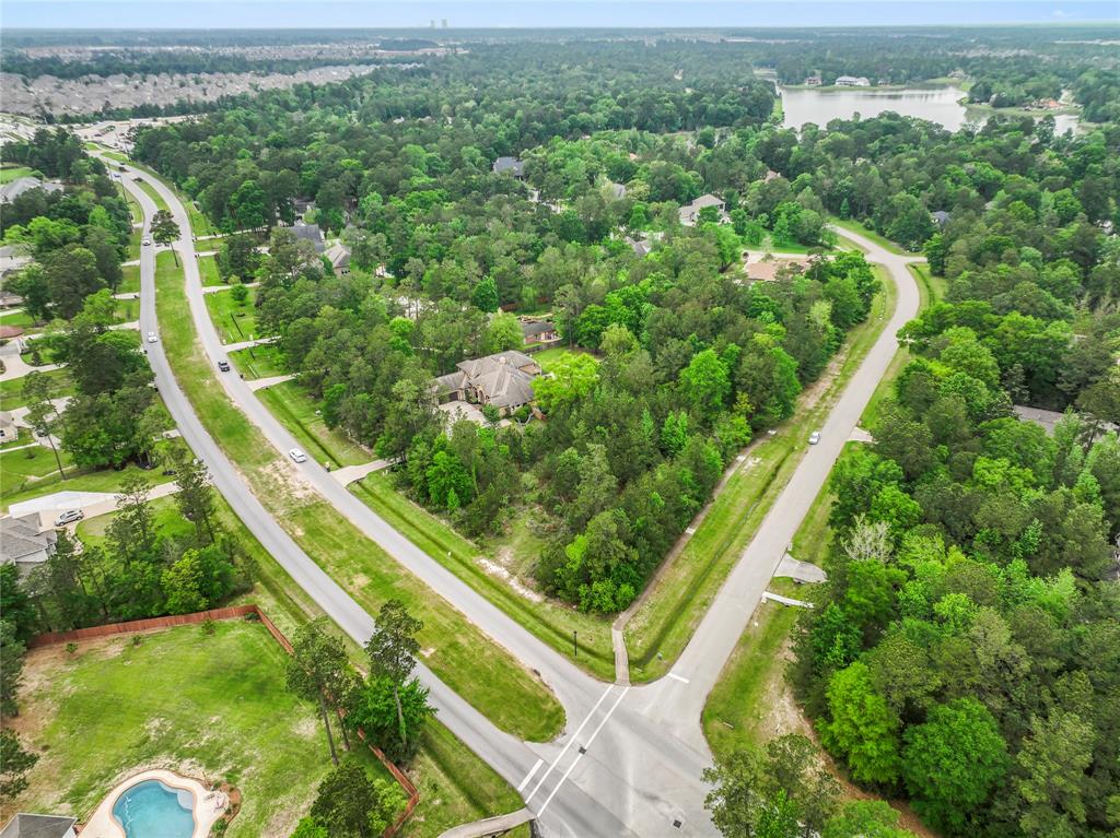 an aerial view of residential houses with outdoor space and trees