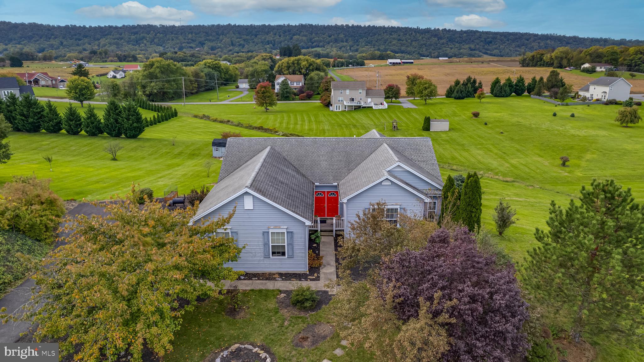 an aerial view of a house with a yard