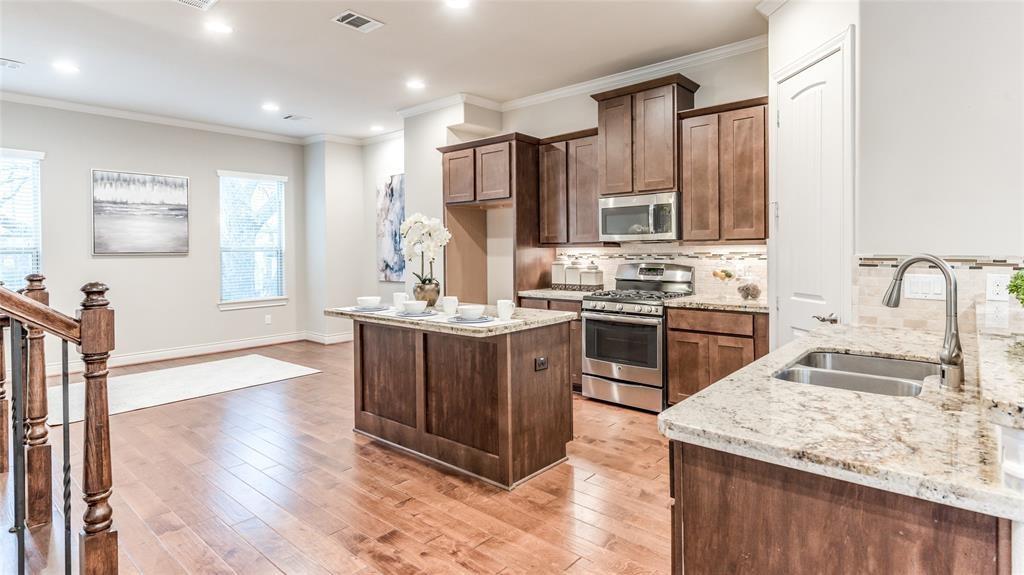 a kitchen with a sink stove and cabinets