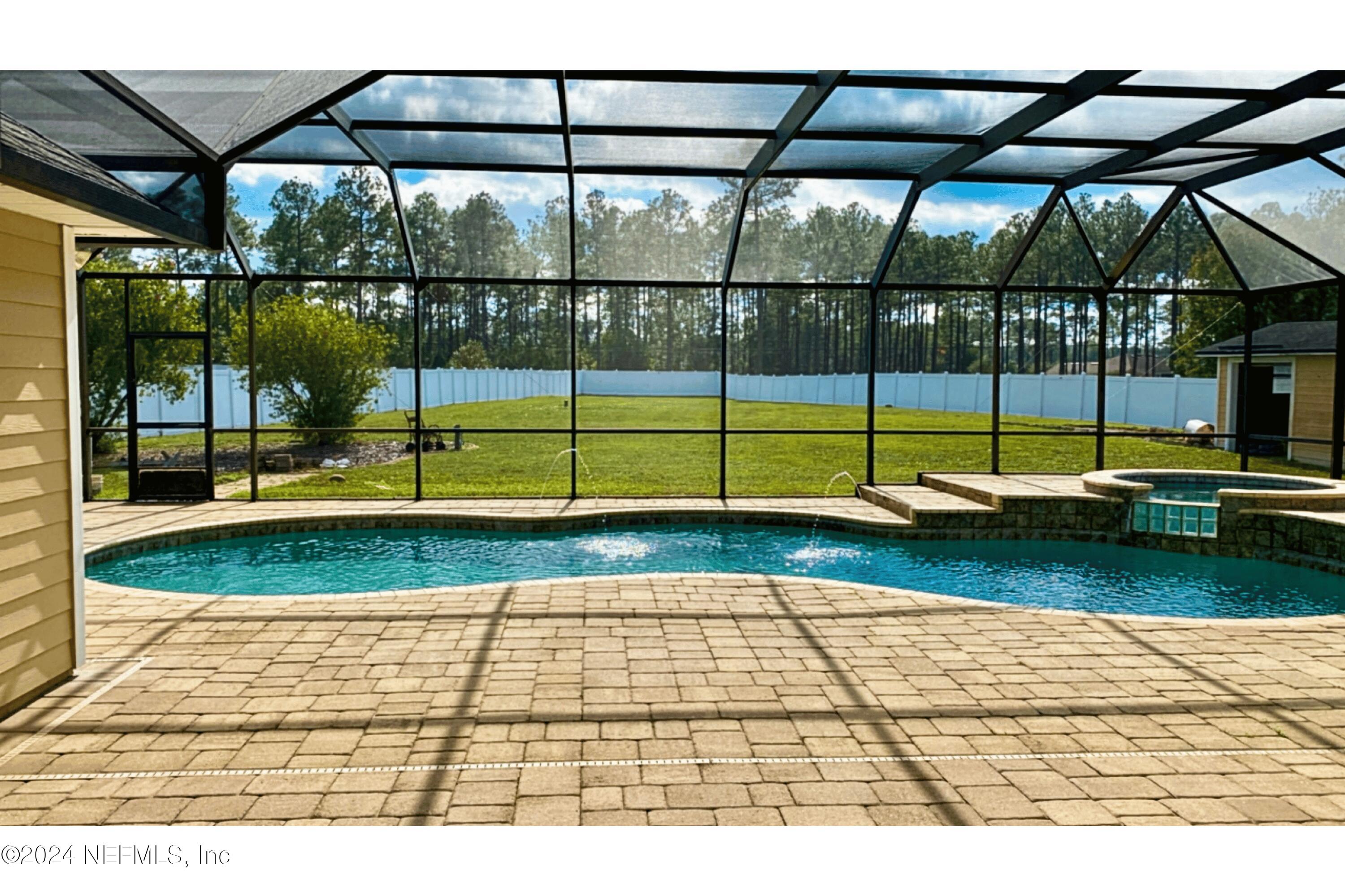 a view of swimming pool with seating space