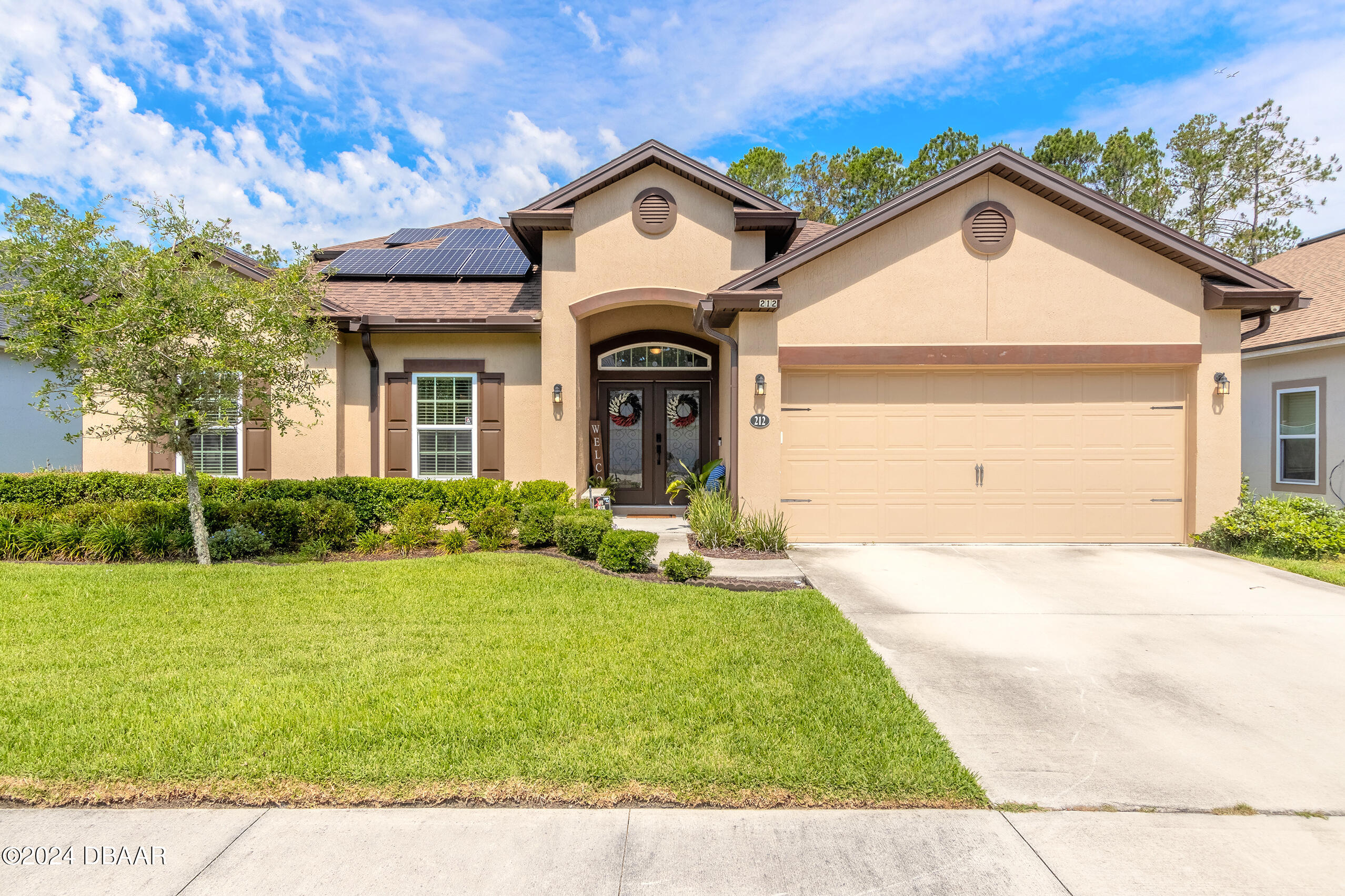 a front view of a house with a yard