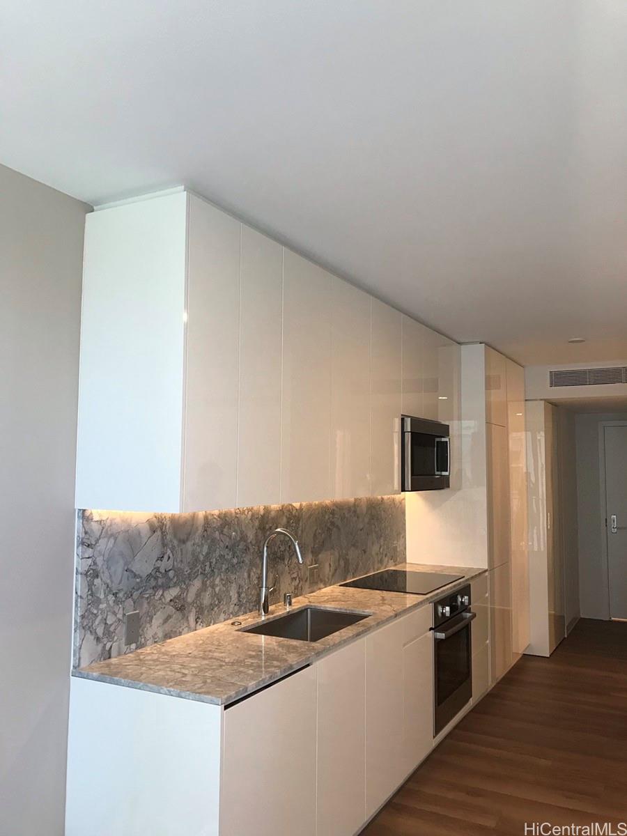 a kitchen with stainless steel appliances granite countertop a sink and a stove top oven