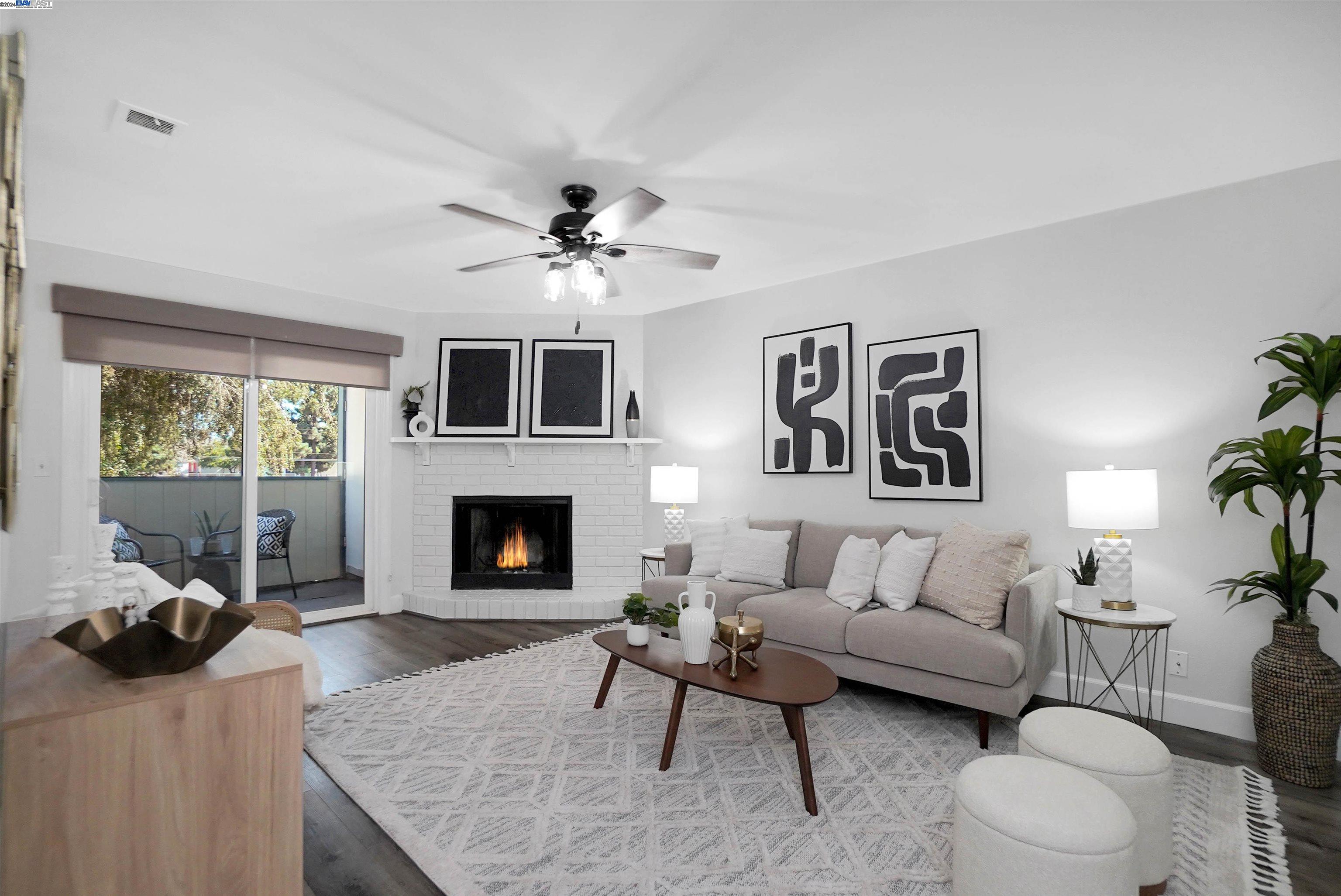 a living room with furniture a window and a fireplace