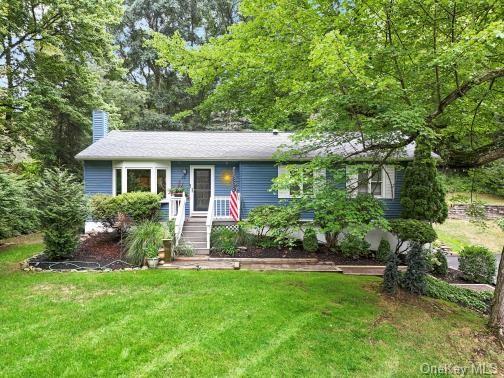 a front view of a house with a garden and plants