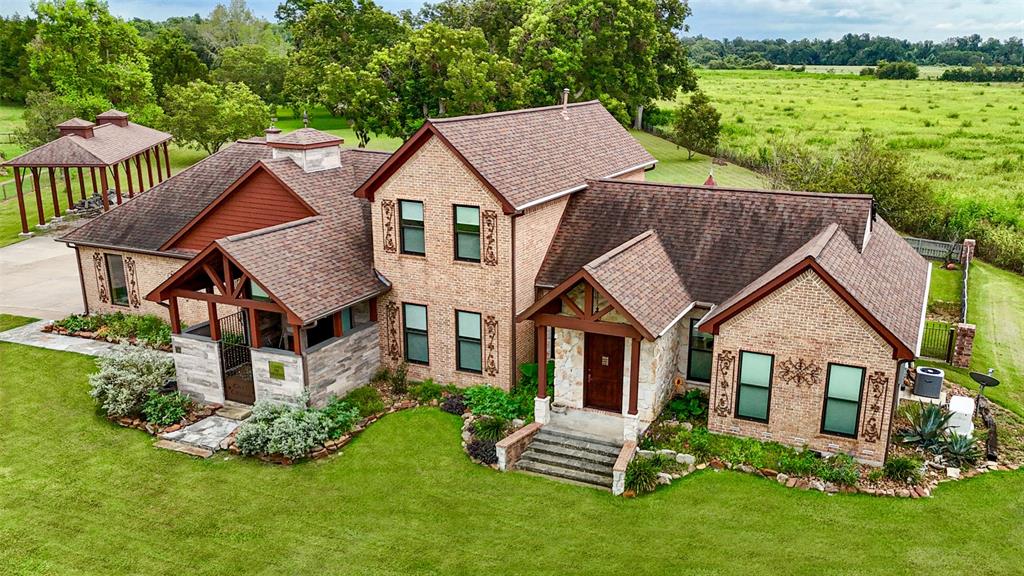 an aerial view of a house with a yard table and chairs