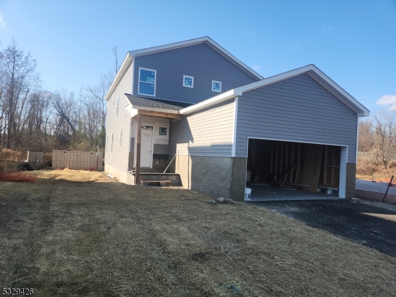 a view of a house with a yard and garage