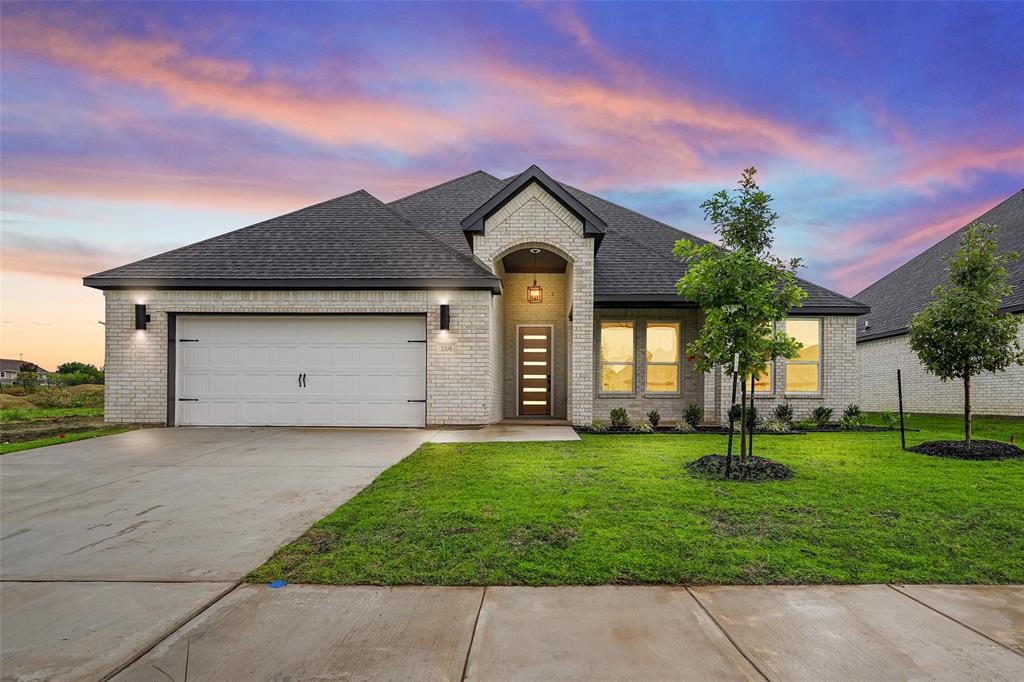 a front view of a house with a yard and garage