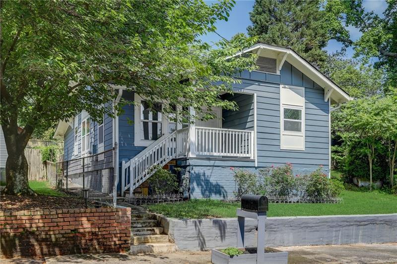 a house that has a tree in front of the house