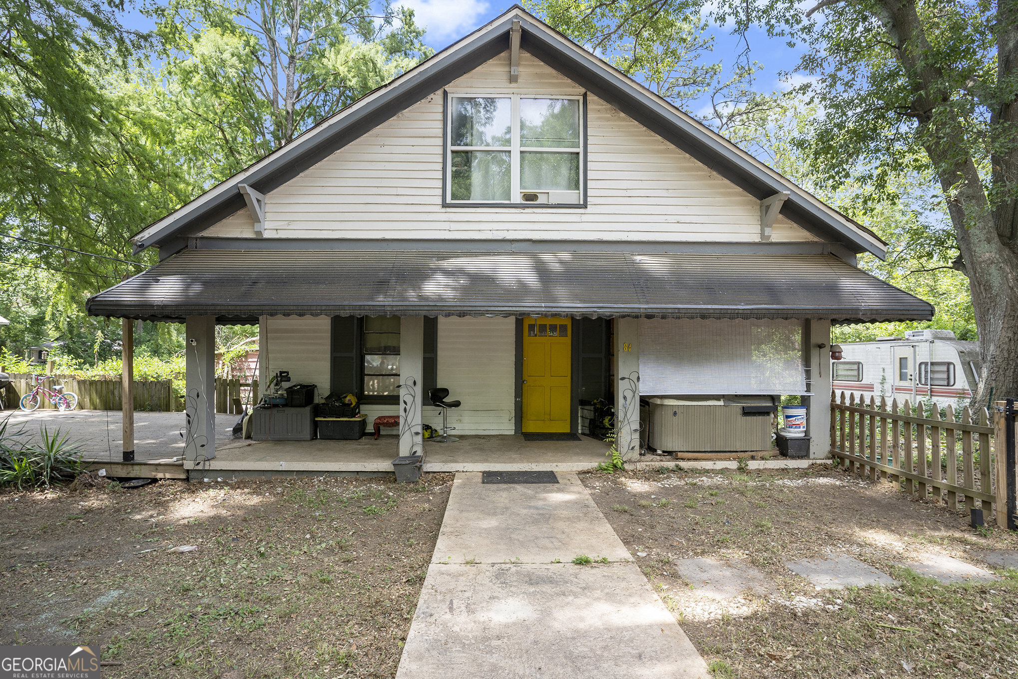 a front view of a house with a yard outdoor seating and garage