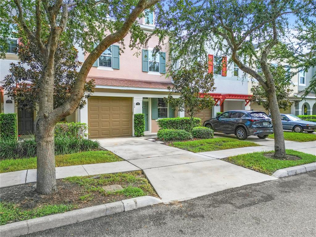 a front view of house with yard and green space