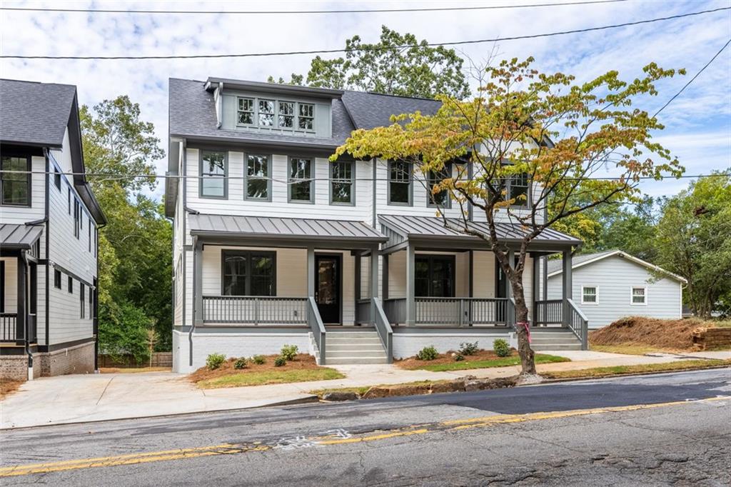 a front view of a house with a tree