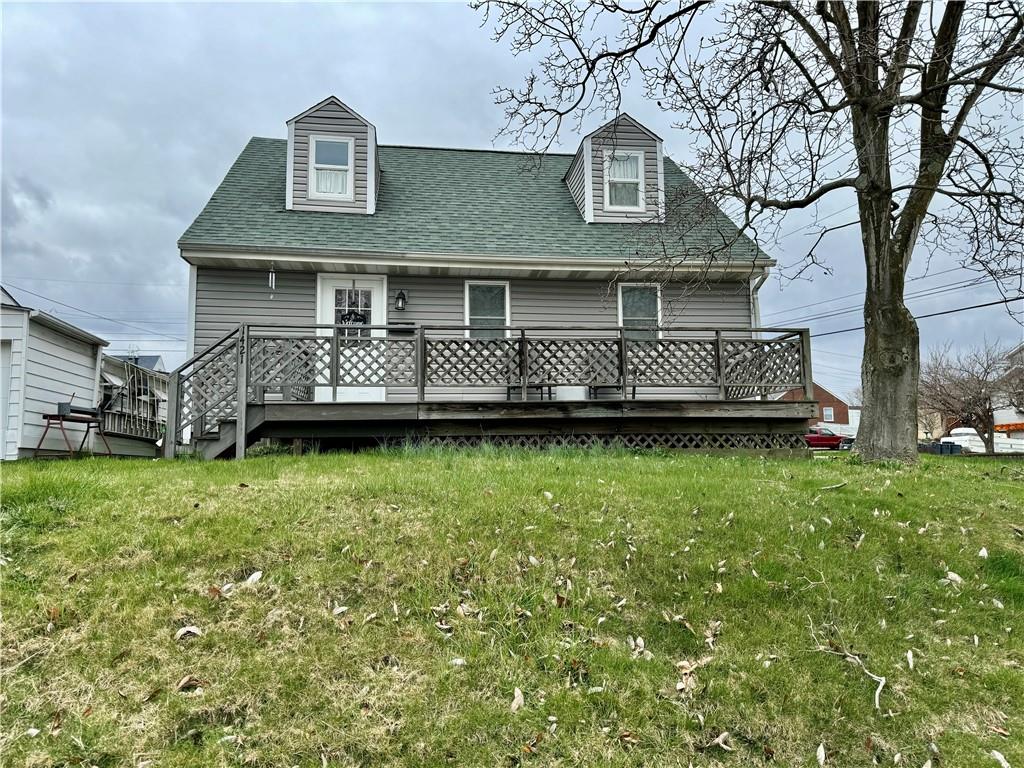 a front view of a house with a garden and deck