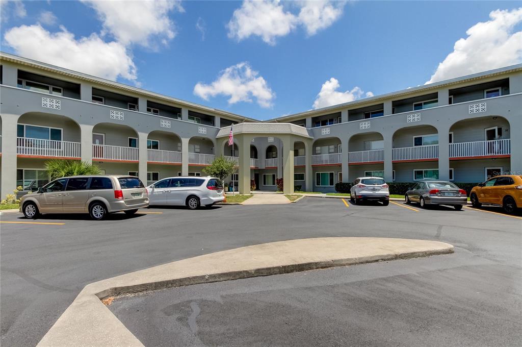 a couple of cars parked in front of building