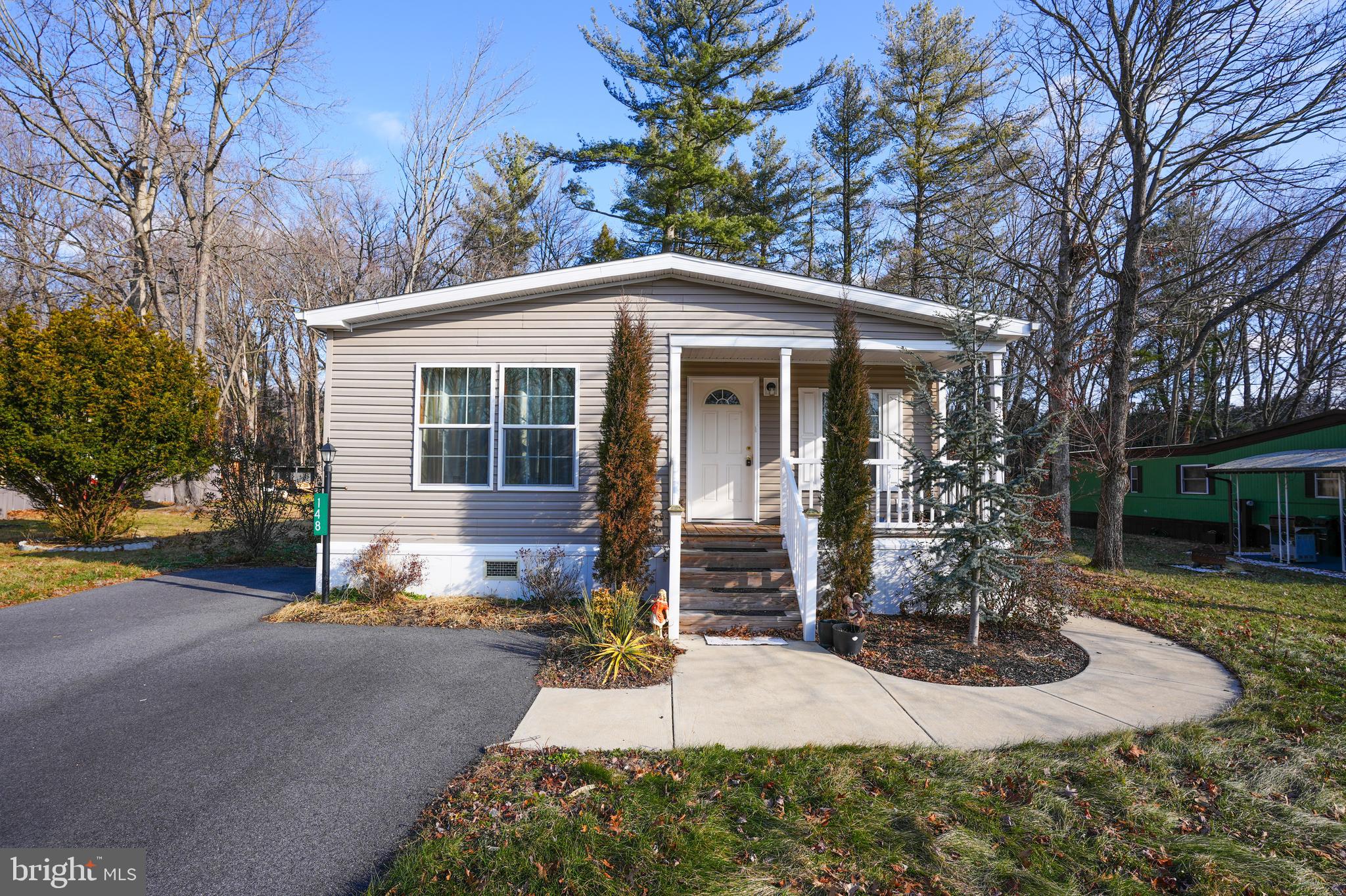 a front view of a house with porch and garden