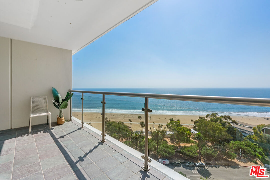 a balcony with view of lake view and a floor to ceiling window