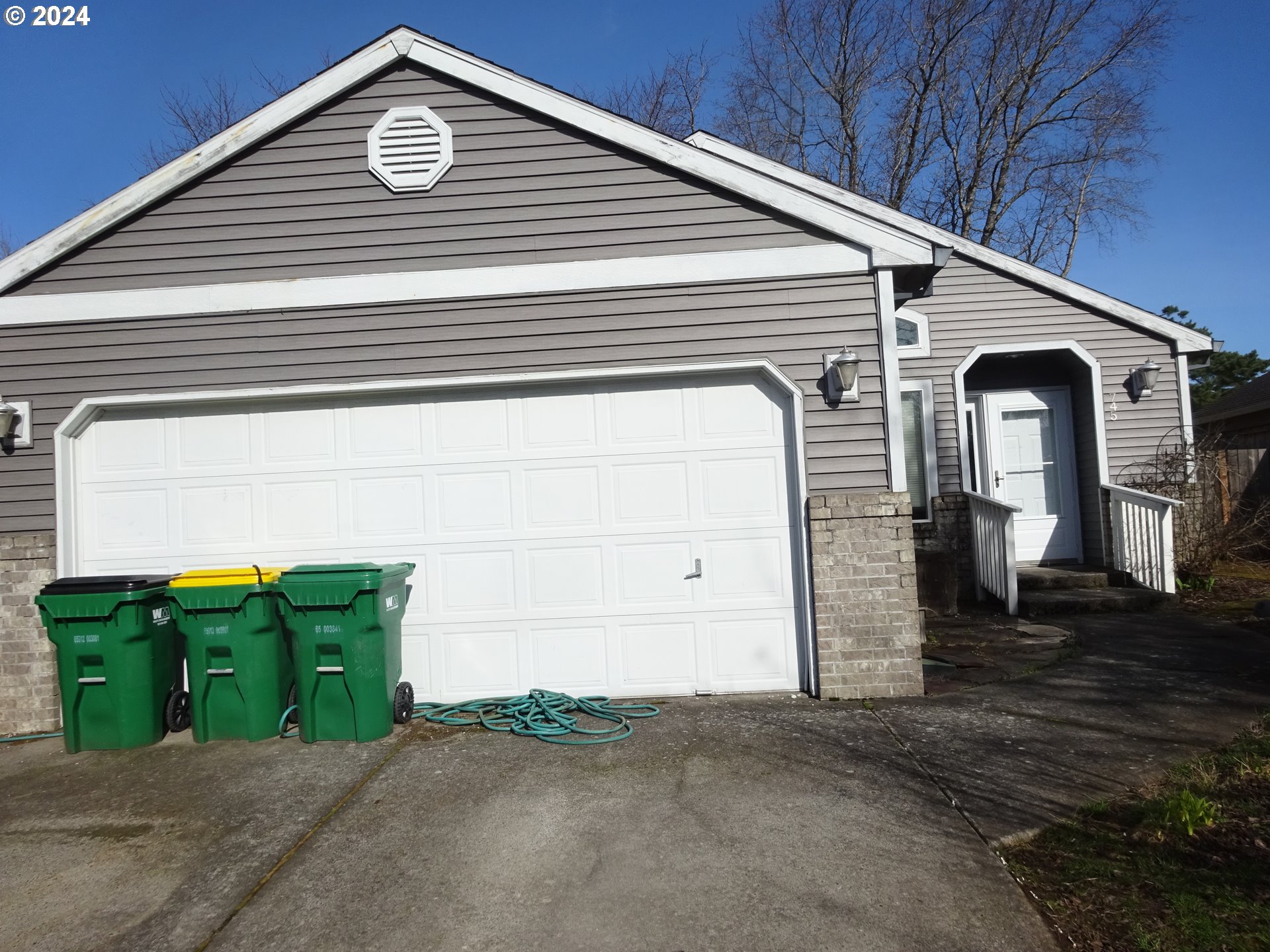 a view of a blue house with yard