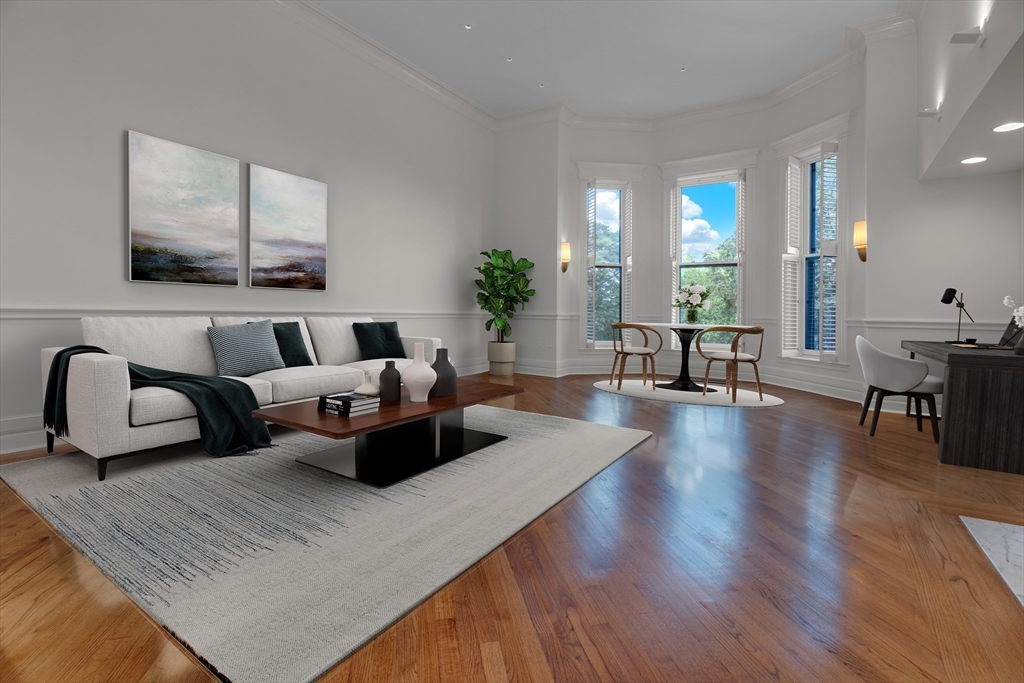 a living room with furniture and wooden floor