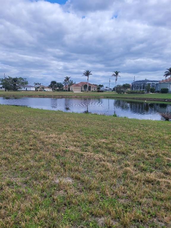 a view of a lake with houses in the back