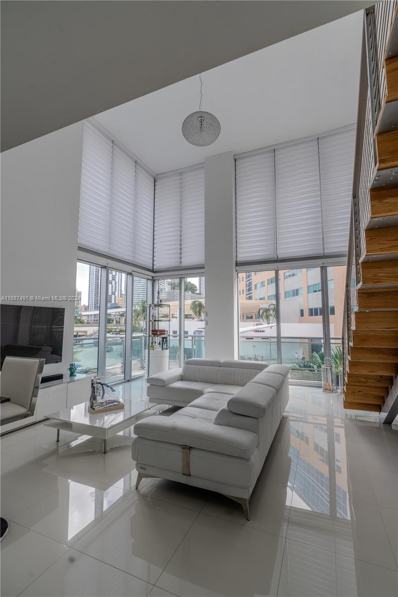 a bedroom with furniture and large windows