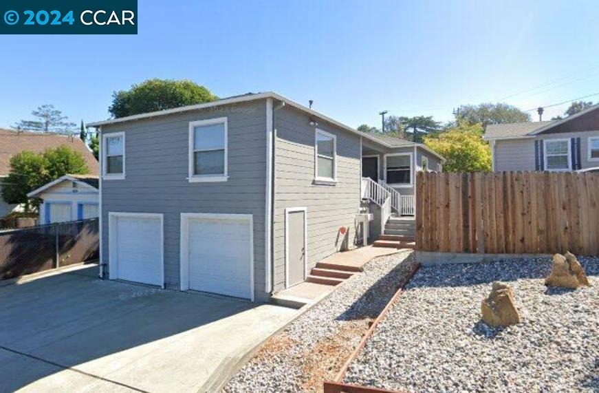 a backyard of a house with wooden fence