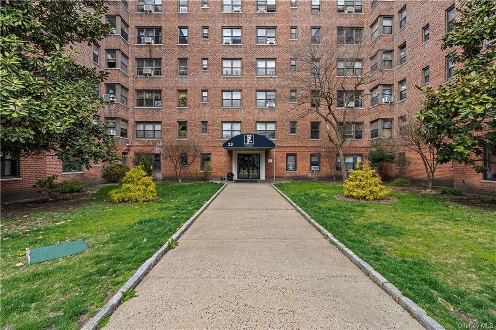 a front view of a building with a garden