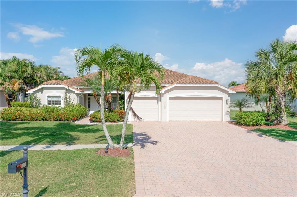 a front view of a house with a yard and garage