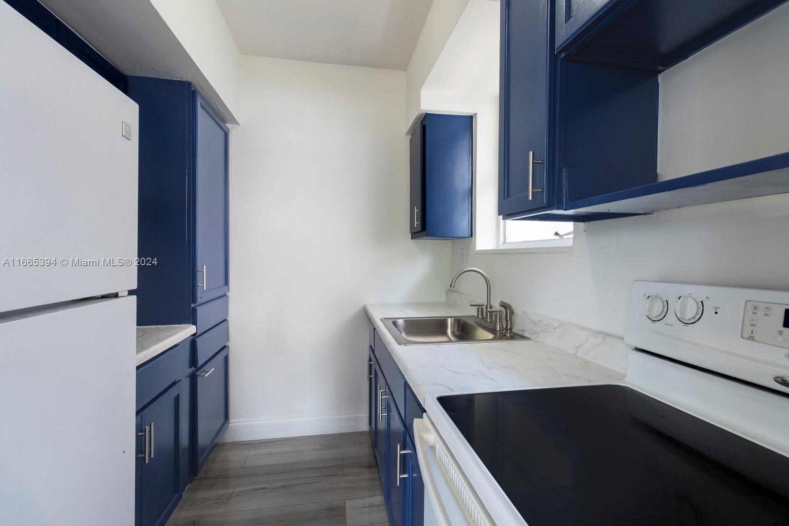 a kitchen with a stove and a refrigerator