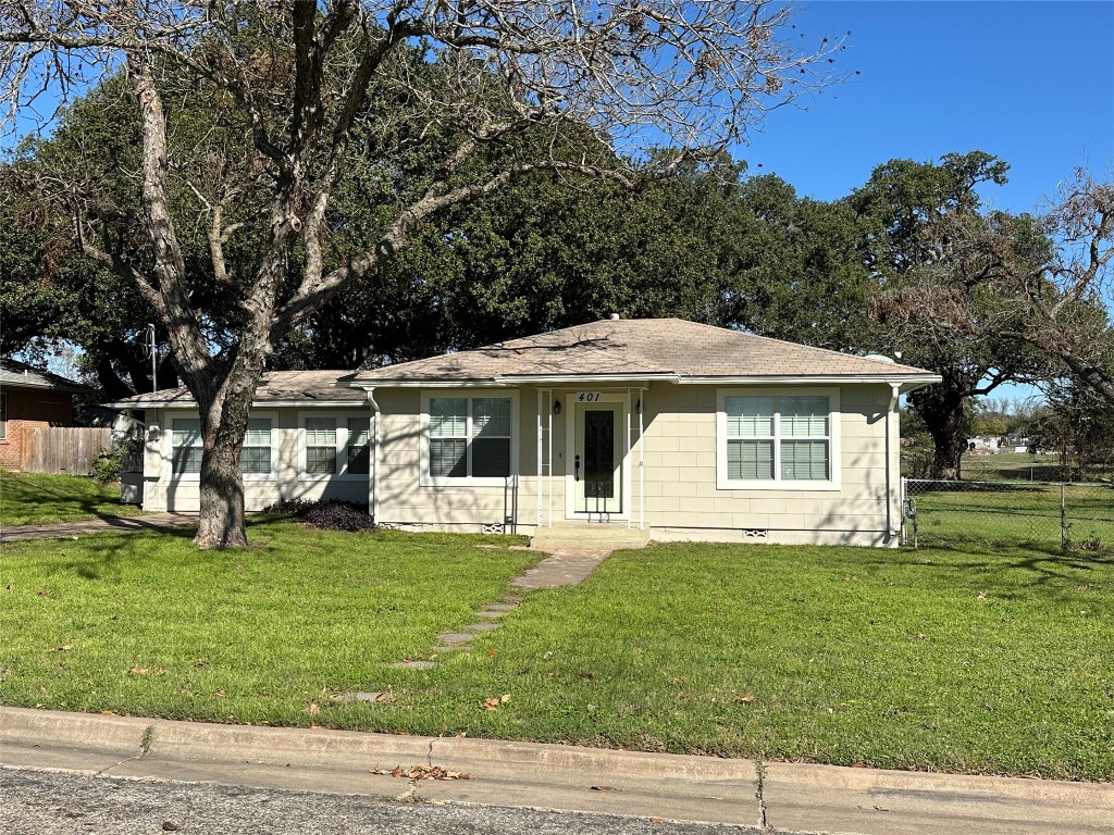 a front view of house with yard and green space