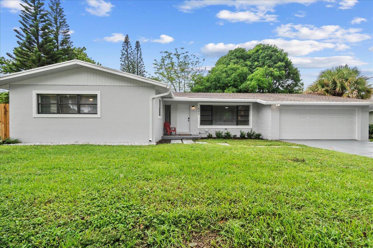 a front view of house with yard and outdoor seating