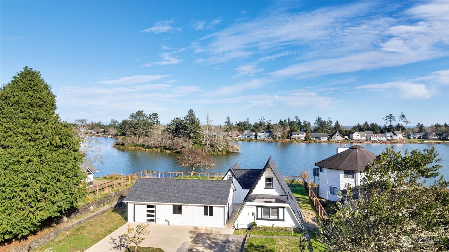 an aerial view of a house with a lake view