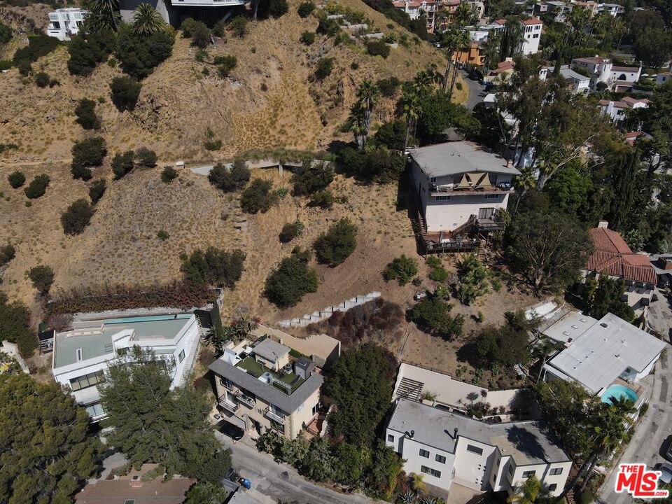 an aerial view of a house with a yard