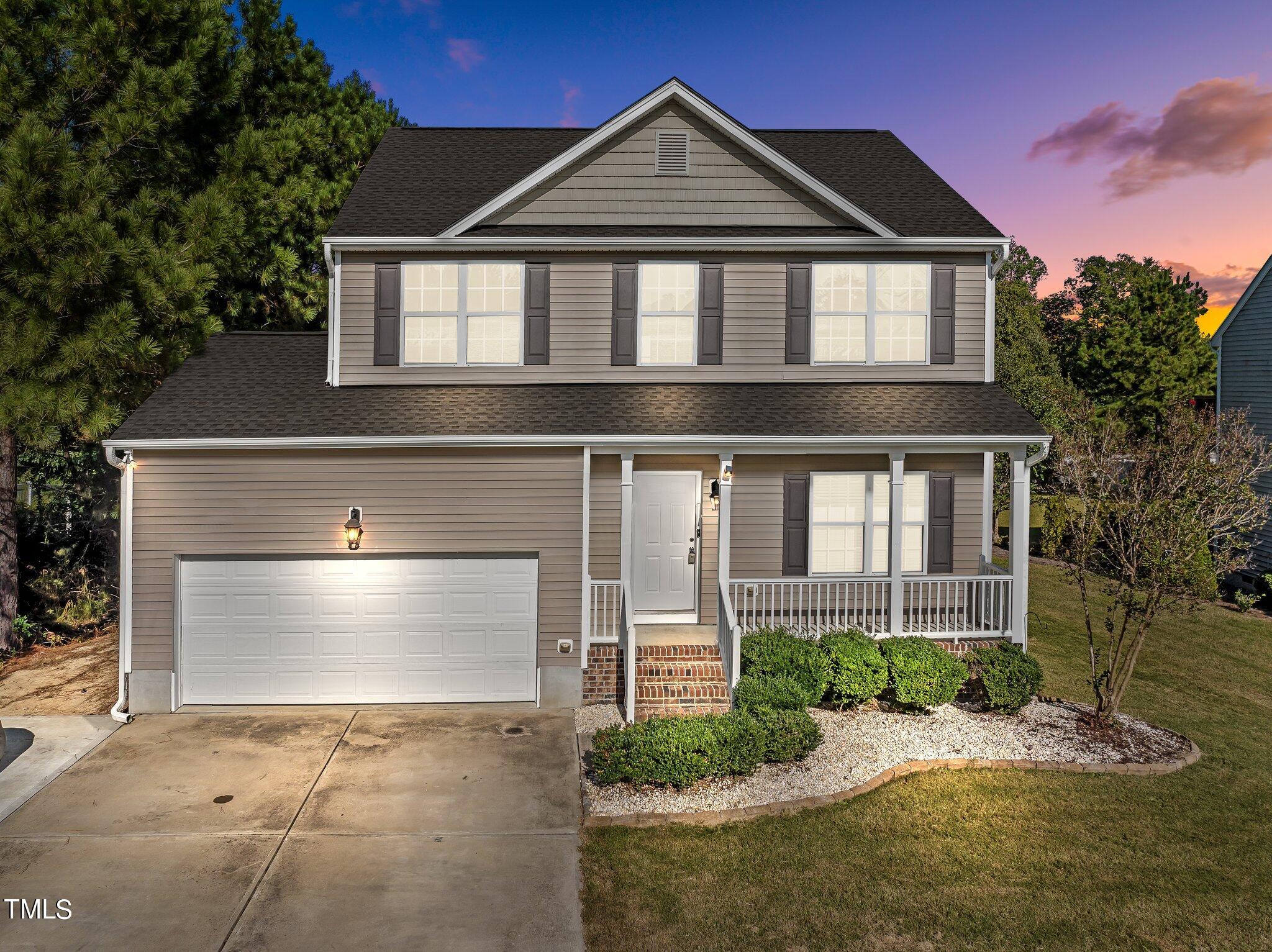 a front view of a house with a yard and garage