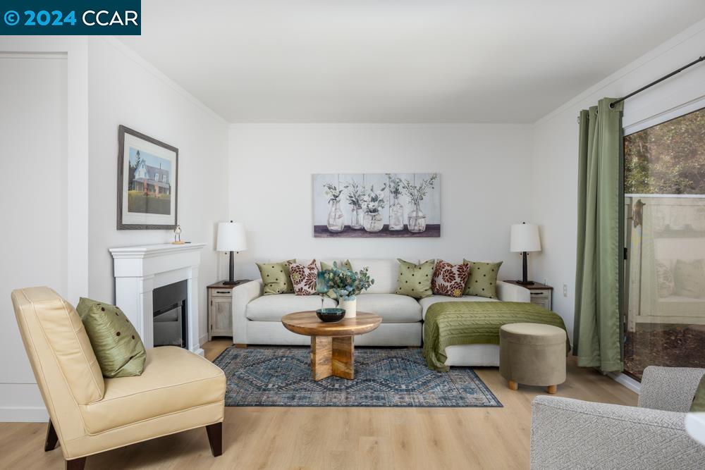 a living room with furniture a fireplace and a table