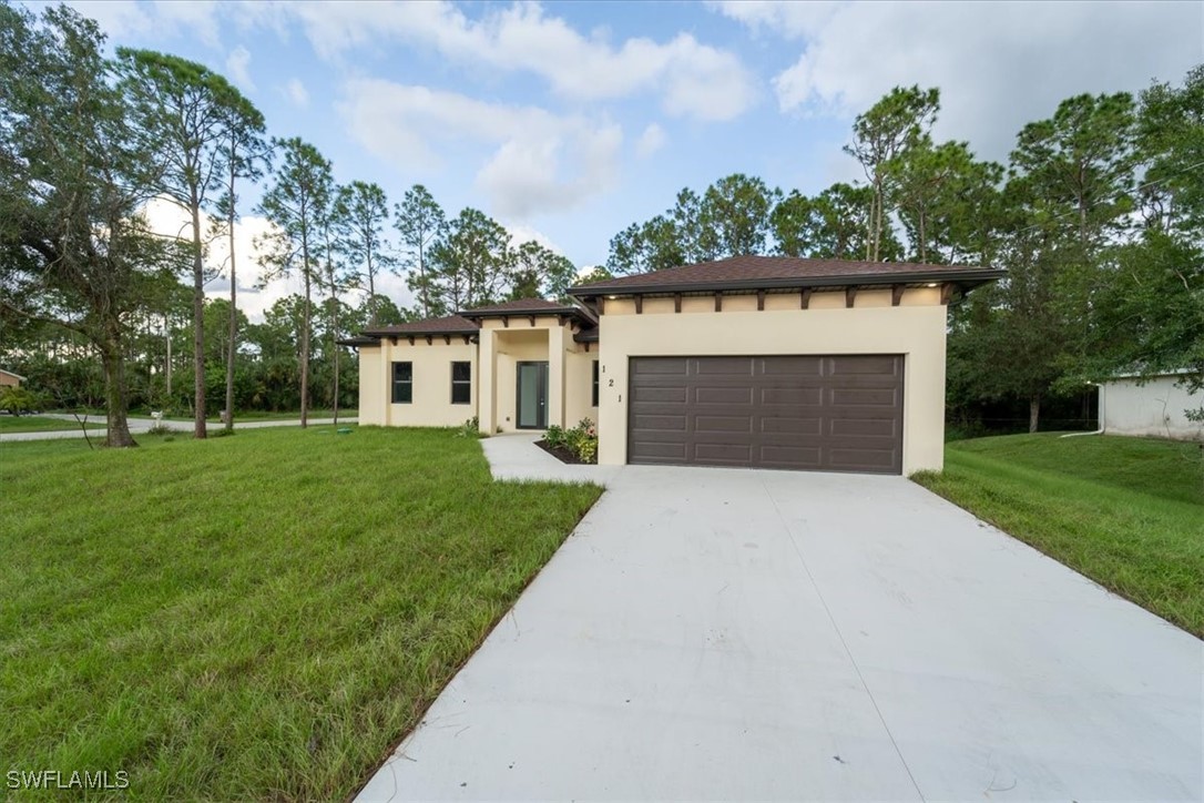 a front view of a house with a yard and garage